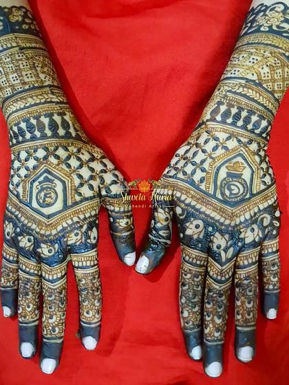 This is a bold and modern back-hand design for an engagement. It features a geometric pattern with the couple's initials and ring motifs, using a meenakari style for a striking, colorful effect.