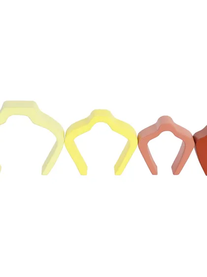 The individual pieces of a wooden shell arch stacker, laid out to show their different sizes.