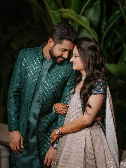 A romantic portrait of the couple amidst lush greenery. Their loving gaze and gentle embrace create a beautiful and timeless image.