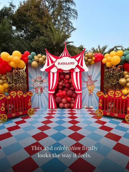 Welcome to 'Rayaland'! For this grand first birthday, we created a full-scale circus theme outdoors. From the custom entrance and character props to the vibrant balloon arrangements and checkered flooring, we handled every detail to create a joyful, immersive world for the little one and their guests.
