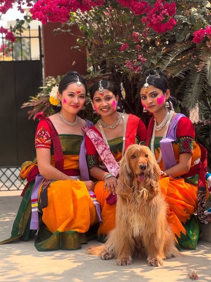 Posto, the star of the show, posing with a group of ladies in their traditional attire for Basanta Utsav.