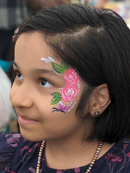 A lovely floral design with pink roses and green leaves, a beautiful and elegant choice for a young girl.