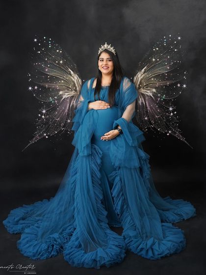 A magical, angelic portrait. The addition of sparkling wings to this beautiful blue gown creates a truly ethereal and unforgettable image.