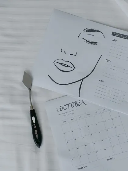 Bridal trials are where the magic begins. This image captures the tools of my trade, including a face chart and calendar, which I use to meticulously plan and document each bride's unique look.