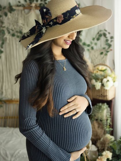 A chic and understated portrait featuring a stylish sun hat. This pose adds a touch of fashion to the relaxed and natural feel of the boho session.