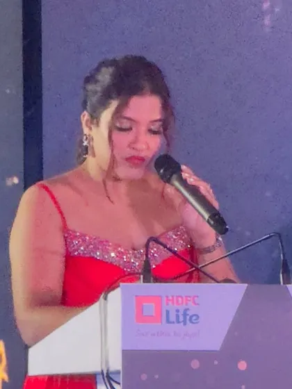 A focused moment at the podium. As a host for financial institutions, I understand the importance of a formal and respectful tone.