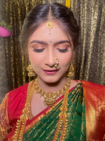 Another close-up showcasing the flawless base and the traditional maang tikka. The makeup is designed to be long-lasting and picture-perfect.