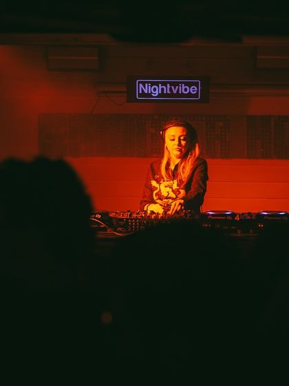 Playing for the Nightvibe crew in Delhi. The silhouette of the crowd against the stage lighting shows the intimate yet energetic atmosphere of the night.