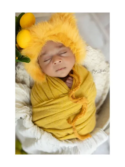 Our little lion cub, complete with a fuzzy mane bonnet, is the king of this photoshoot. Themed outfits and props are all available in my studio.