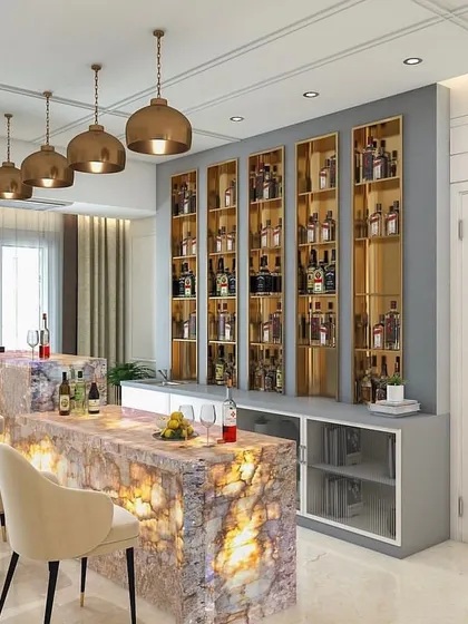 A dedicated home bar with an illuminated feldspar marble counter. The back wall features custom shelving with gold accents and integrated lighting to beautifully display the collection.