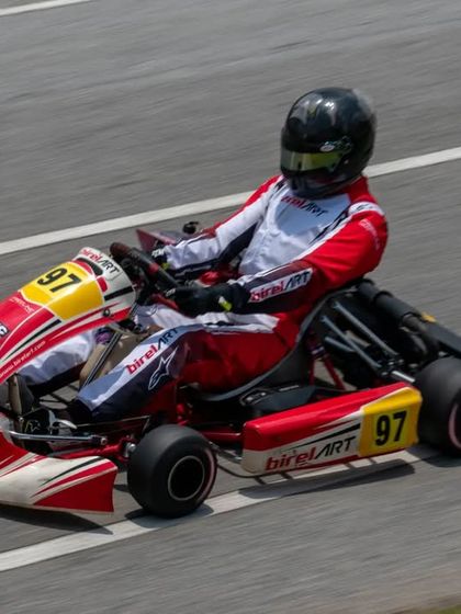 An overhead action shot of Muktak Joshi on the track, demonstrating proper racing lines and driver posture, key elements of our coaching curriculum.