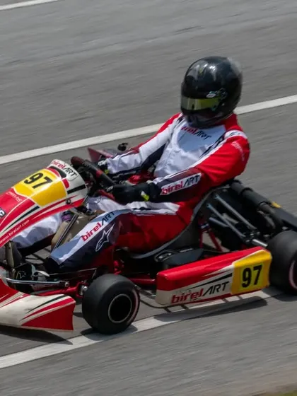 An overhead action shot of Muktak Joshi on the track, demonstrating proper racing lines and driver posture, key elements of our coaching curriculum.