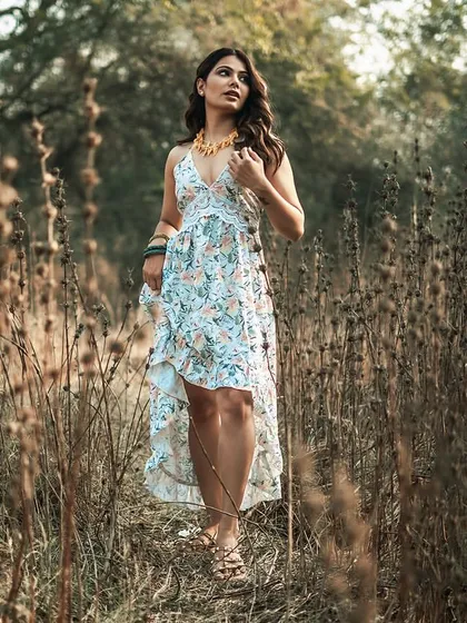 I often direct models to interact with their environment to make the photos feel more dynamic. In this shot, the model walks through a field of tall grass, which adds texture and a sense of place to this lifestyle fashion image.