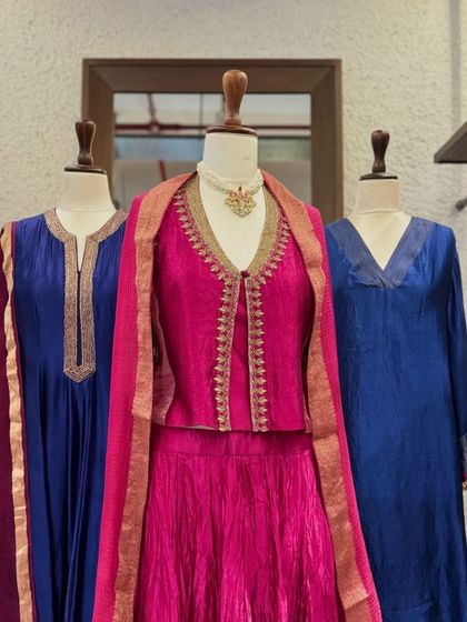 A closer look at the fuchsia pink jacket-style kurta paired with a crushed skirt, a modern take on a traditional silhouette.
