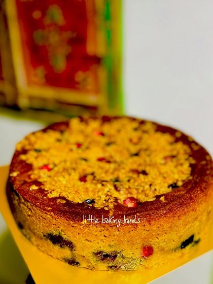 A strawberry and blueberry crumble cake, showcasing the delicious texture of the crumble topping over the soft, berry-filled cake.