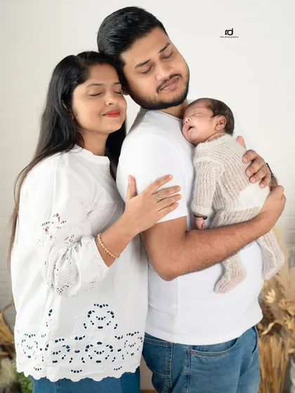 A moment of pure peace and love. The family huddles together, eyes closed, just soaking in the feeling of being together with their new baby.