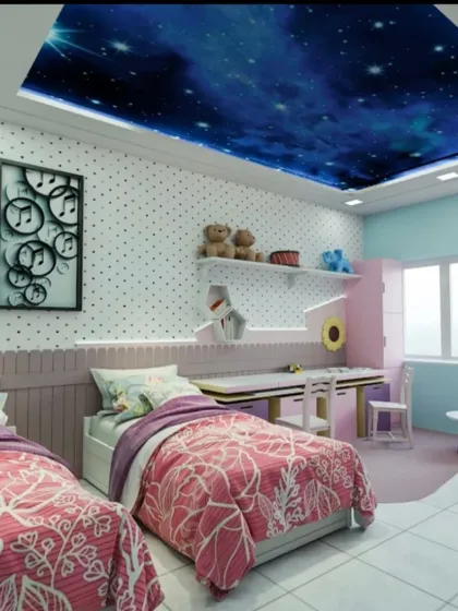 This shared kids' room features a stunning galaxy ceiling that makes you feel like you're sleeping under the stars. The design includes twin beds, a shared study desk, and playful decor like the polka-dot wallpaper.