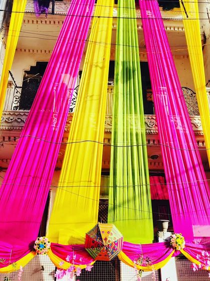 A close-up of the multi-coloured drapes, showing the texture and vibrancy of the fabrics used for house exteriors.