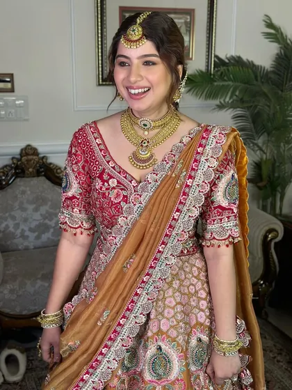 The joy on her face says it all. Her makeup is radiant and glowing, a perfect match for her vibrant personality and stunning outfit.