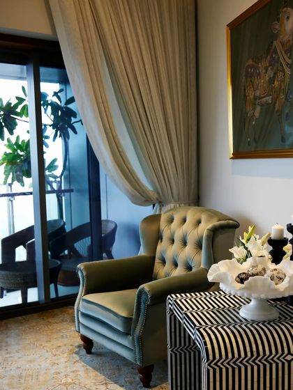 This reading corner on the 76th floor of a Mumbai home offers breathtaking views. I layered a handcrafted black and white inlay table from Rajasthan with a classic armchair and Pichwai-style art to create an elegant space that celebrates Indian craftsmanship.