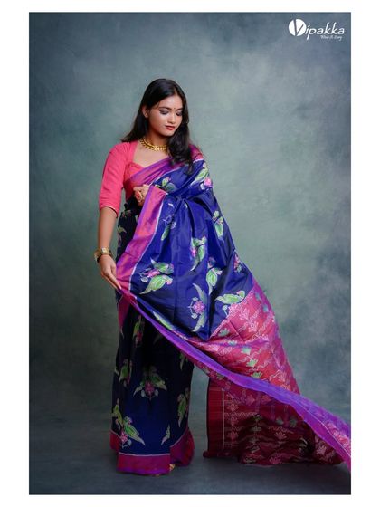 A shot that captures the movement of the pallu, showing the fabric's texture and the richness of the print.