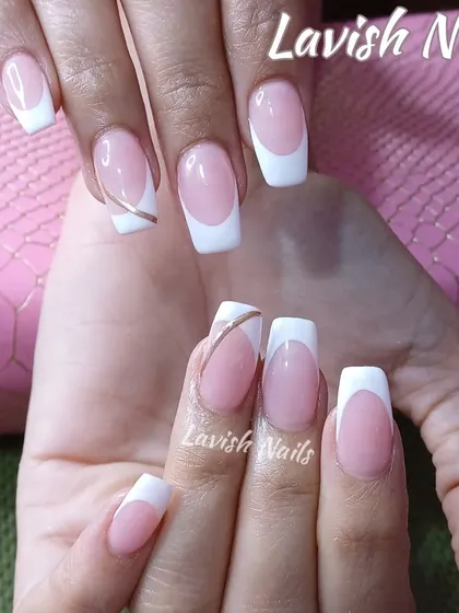A classic white French manicure on square nails with a delicate gold line accent.