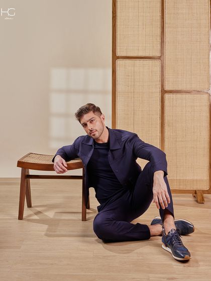 A full view of the navy monotone ensemble, showcasing its sophisticated and sharp silhouette. It’s an effortless choice for an airport look or can be styled separately to elevate an after-party fit.