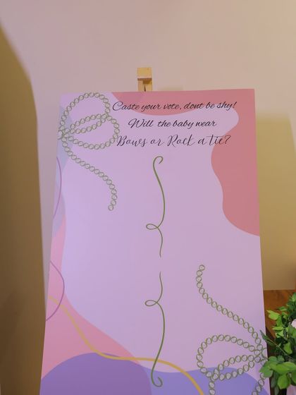 A "Bows or Ties" gender reveal voting board. Guests can cast their vote on this beautifully designed sign, adding an element of anticipation and fun to the baby shower.