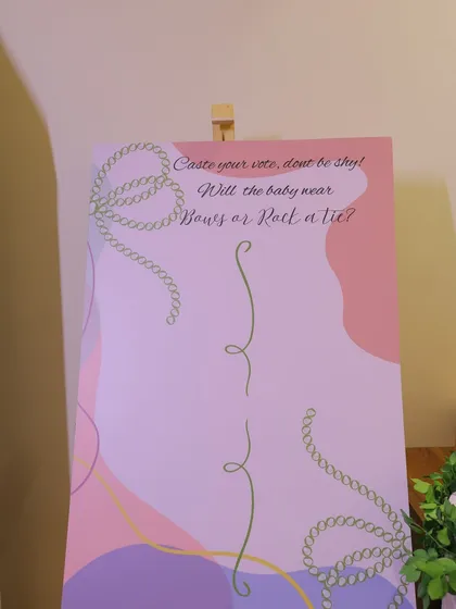 A "Bows or Ties" gender reveal voting board. Guests can cast their vote on this beautifully designed sign, adding an element of anticipation and fun to the baby shower.
