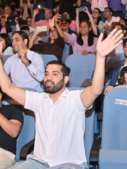 The energy from the audience was incredible. Here I am, cheering right back at them from the crowd, feeling just as excited as they are.