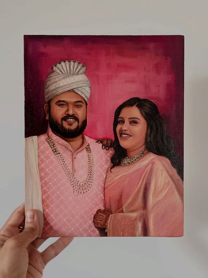 This portrait of a couple in traditional wedding attire features a rich, warm background that complements their outfits beautifully.