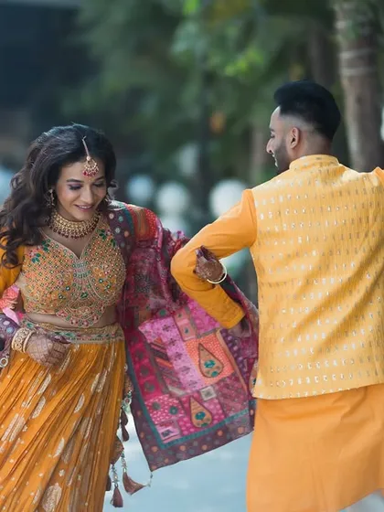 Dancing into their future together. This action shot from a pre-wedding event captures the couple's joyful spirit and movement.