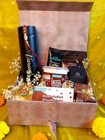 This Rakhi hamper for a brother is filled with everything he loves. It features a personalized temperature-control bottle, coffee-scented grooming products, protein bars, and of course, chocolate.
