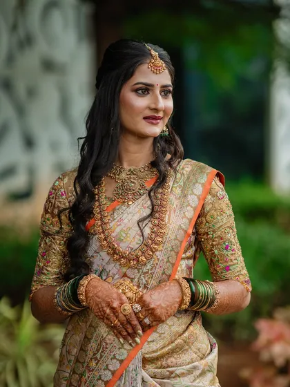 My beautiful client-turned-family, Chethana, looks timeless in this white and pink Kanchipuram saree. I designed a heavily handcrafted bridal blouse with intricate zardozi work to complement the saree's elegance for her special day.