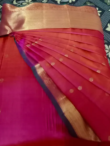 A beautiful pink saree with a simple gold border. The pleats are customized according to body type for a flattering and comfortable fit.