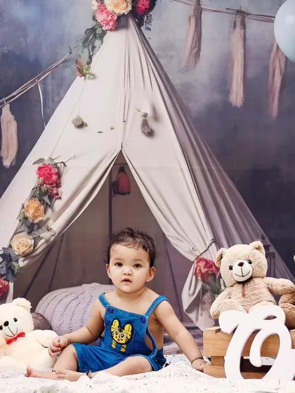 Our boho teepee setup is perfect for a dreamy and rustic first birthday photoshoot, complete with soft lighting and teddy bears.