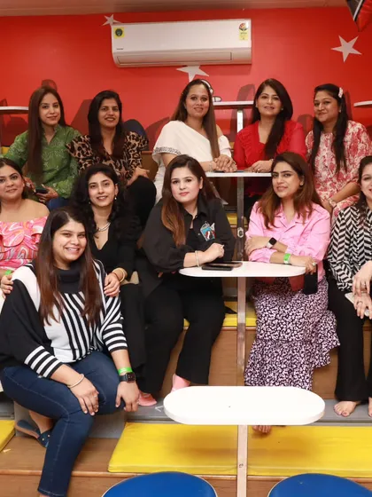 A happy group of moms enjoying the party from our comfortable, tiered seating area while the kids play.