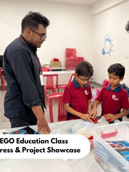 Our instructor and a parent engage with two students at Vidyashilp Academy's project showcase. We foster an environment where learning is a collaborative discussion between students, parents, and teachers.