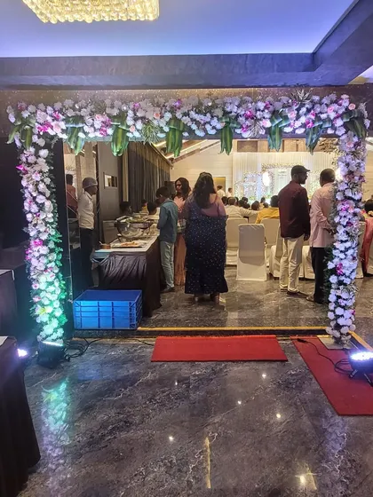 An indoor floral archway I created to frame the buffet or seating area at an engagement party. The integrated lighting adds a festive glow to the floral arrangement.