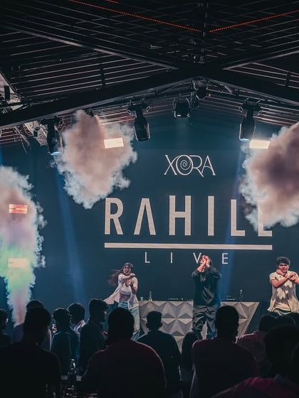 A DJ performs on stage with CO2 jets erupting behind him. I bring concert-level production elements to my club nights to create high-impact moments.