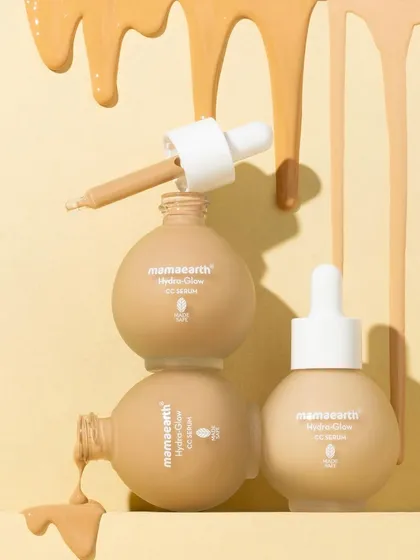 A playful tower of serum bottles with cascading drips of product. This shot is designed to be eye-catching and a little messy, showing off the serum's texture and color in a fun, unconventional way.