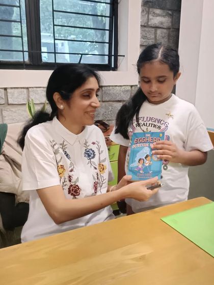 A young reader is thrilled to get her copy of the book signed by the author herself.