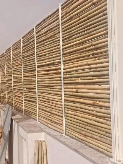A close-up of the bamboo privacy screen being installed on a terrace. We often incorporate natural materials to add warmth and texture to our modern steel and glass structures.