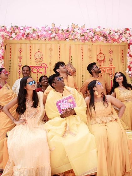 Another lively group photo from the Haldi ceremony. Capturing these candid, energetic moments is key to creating a memorable wedding album.