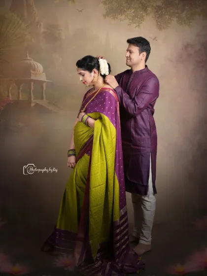 A romantic studio portrait of a couple in traditional attire, with the husband-to-be helping his wife with her jewelry.