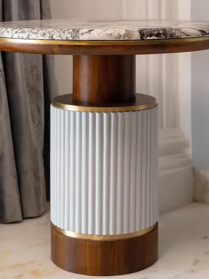 This set of side tables serves as both a utility piece and a luxury accessory for the living room.
