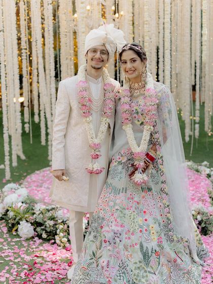 A beautiful shot of the happy couple. Bhoomi's pastel lehenga and radiant makeup create a fairytale aesthetic, perfect for a modern daytime wedding.