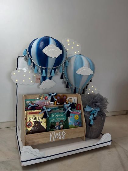 The complete hot air balloon and bookshelf set, featuring light-up clouds that add a magical glow to this baby boy gift hamper.