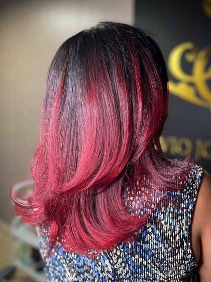 A side view of the fiery red ombre, showcasing the layered cut that complements the bold colour choice.