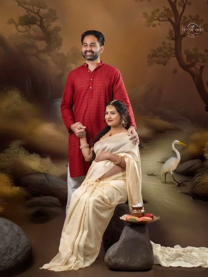 A beautiful couple's portrait set against a painted natural landscape, blending artistry with traditional attire.
